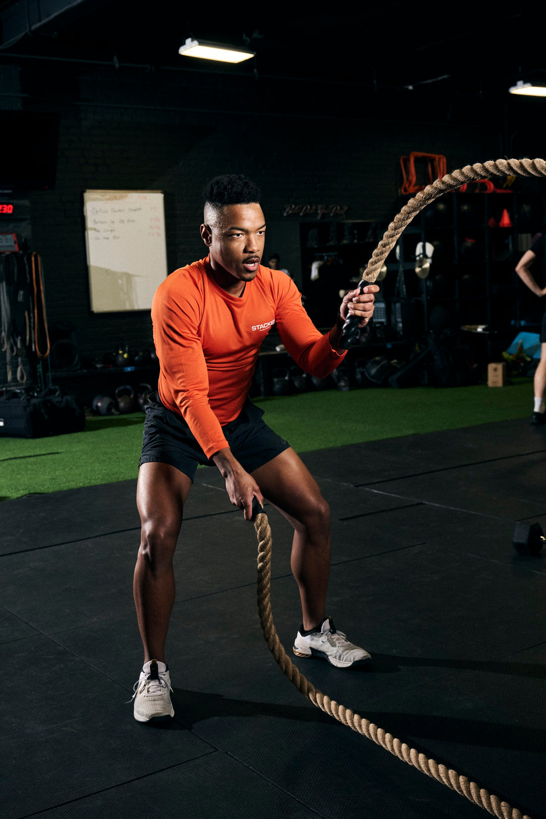 Man working battle ropes in the gym