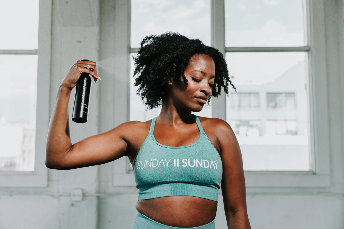 A woman holding a water bottle after a workout, illustrating when plain water covers your hydration needs during exercise.