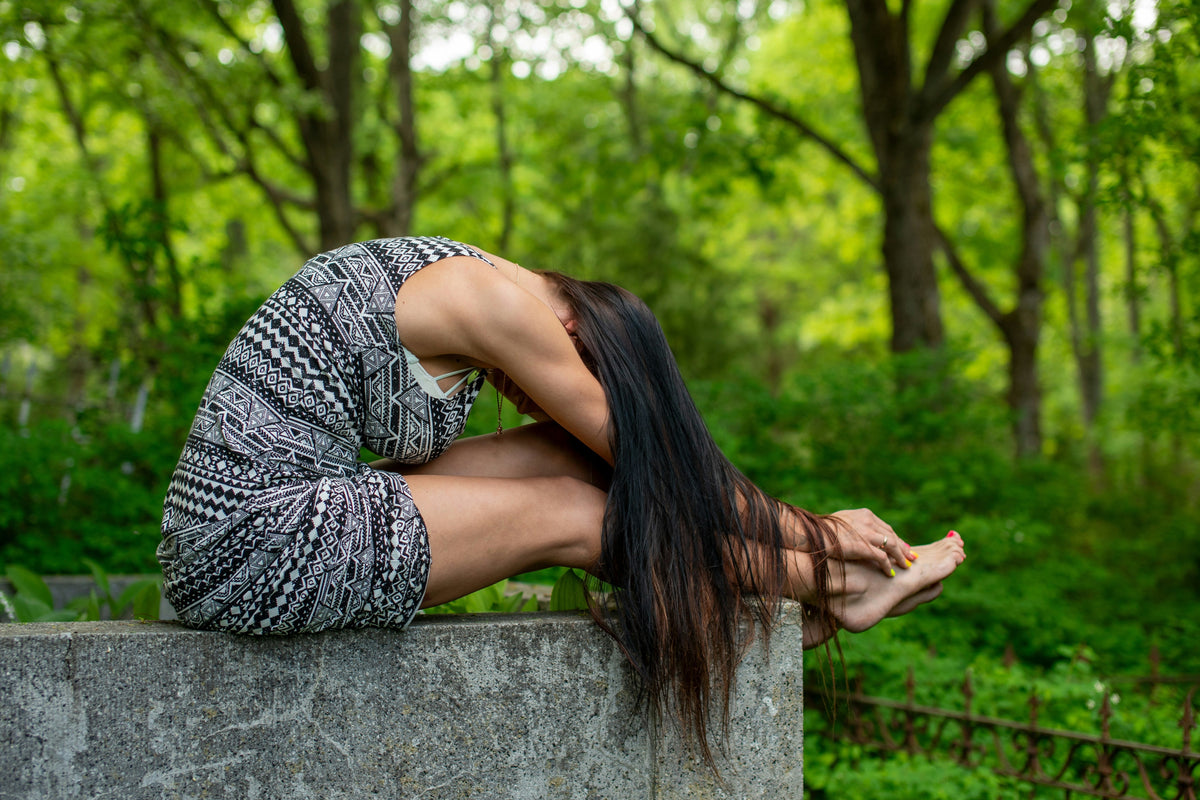 A woman pauses for a calm, mindful stretch outdoors, the kind of mental clarity many women dealing with creatine and brain fog are working toward.
