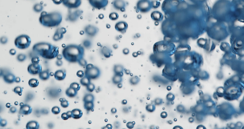 Close-up of blue bubbles on a light gray background