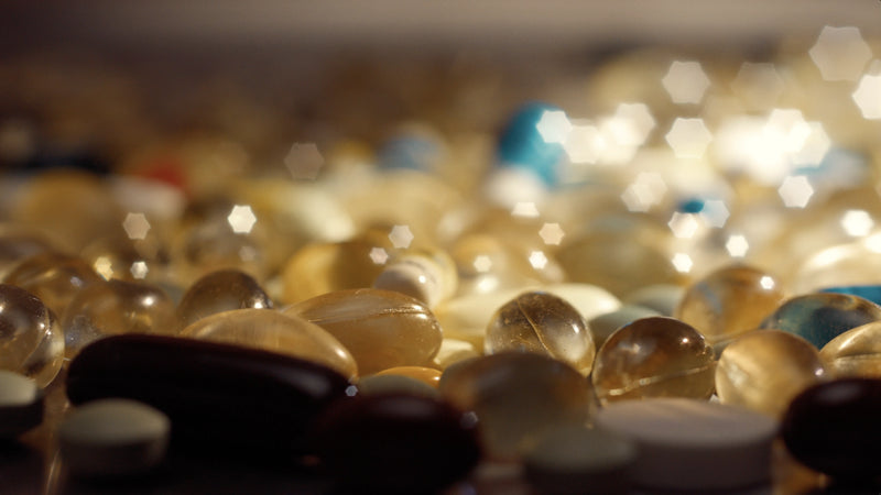 Close-up of various pills and capsules with a blurred background