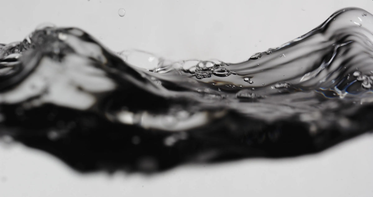 Close-up of swirling black and white liquid on a light background