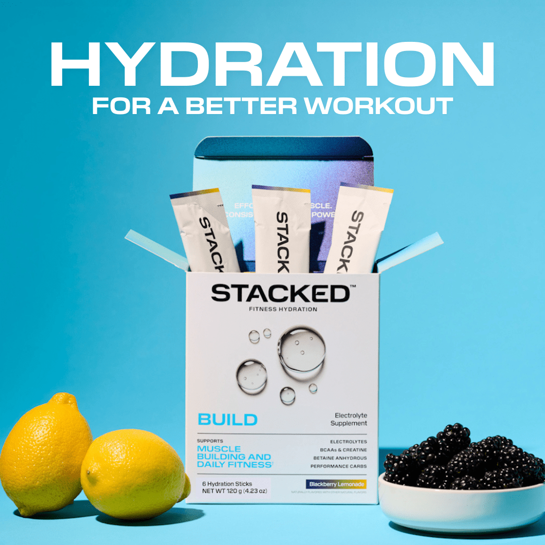Stacked fitness hydration supplement packaging with lemons and blackberries on a blue background